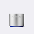 Silver cylindrical razor stand with 'HARRY'S' branding on a light gray background